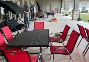 serene and cozy outdoor seating adjacent to a grass courtyard as part of a drug detox treatment program socialization area
