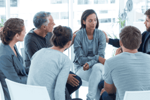 People sitting in a circle and talking about how effective group therapy is for addiction treatment