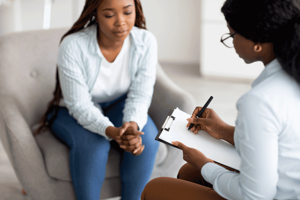 Two people in therapy talking about PTSD treatment benefits